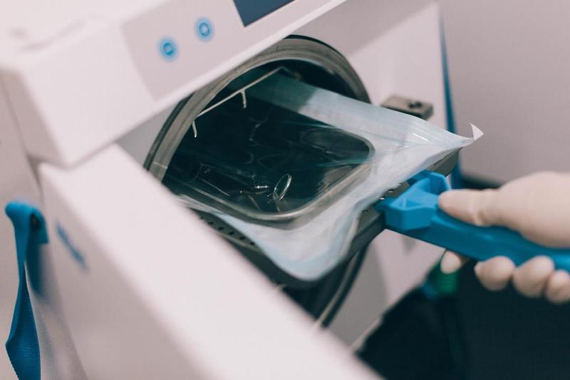 Dental instruments in a sterilisation pouch inside an autoclave